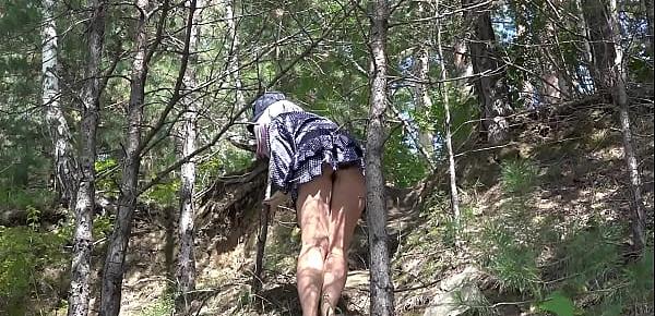  Under a skirt without panties. Hairy pussy and big ass in a short dress climbs mountains in nature.